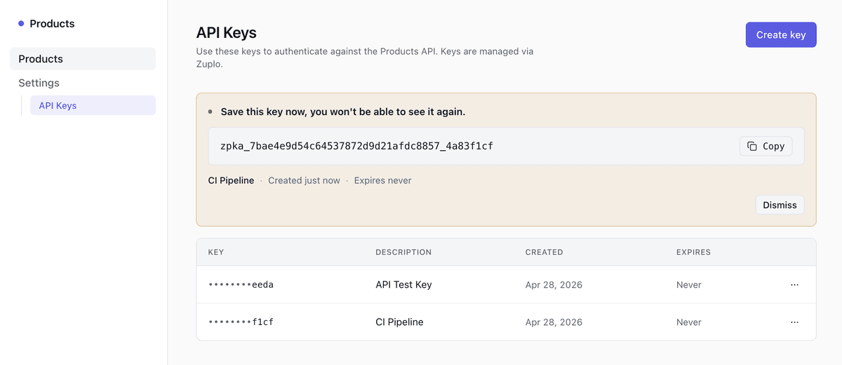 Reference settings page showing the masked keys table with Roll and Revoke actions, plus a one-time reveal banner at the top